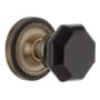Nostalgic Warehouse Rope Solid Brass Rose Privacy Door Knob Set with Black Waldorf Knob and 2-3/4" Backset Antique Brass