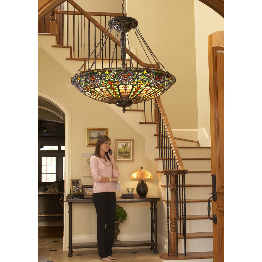 Quoizel Satin Lace hurricane. 24” tall. The lamp features a frosted, light blue  glass shade and base, adorned with a white floral pattern and gold trim.  Can light top and bottom separately, image size:900x900