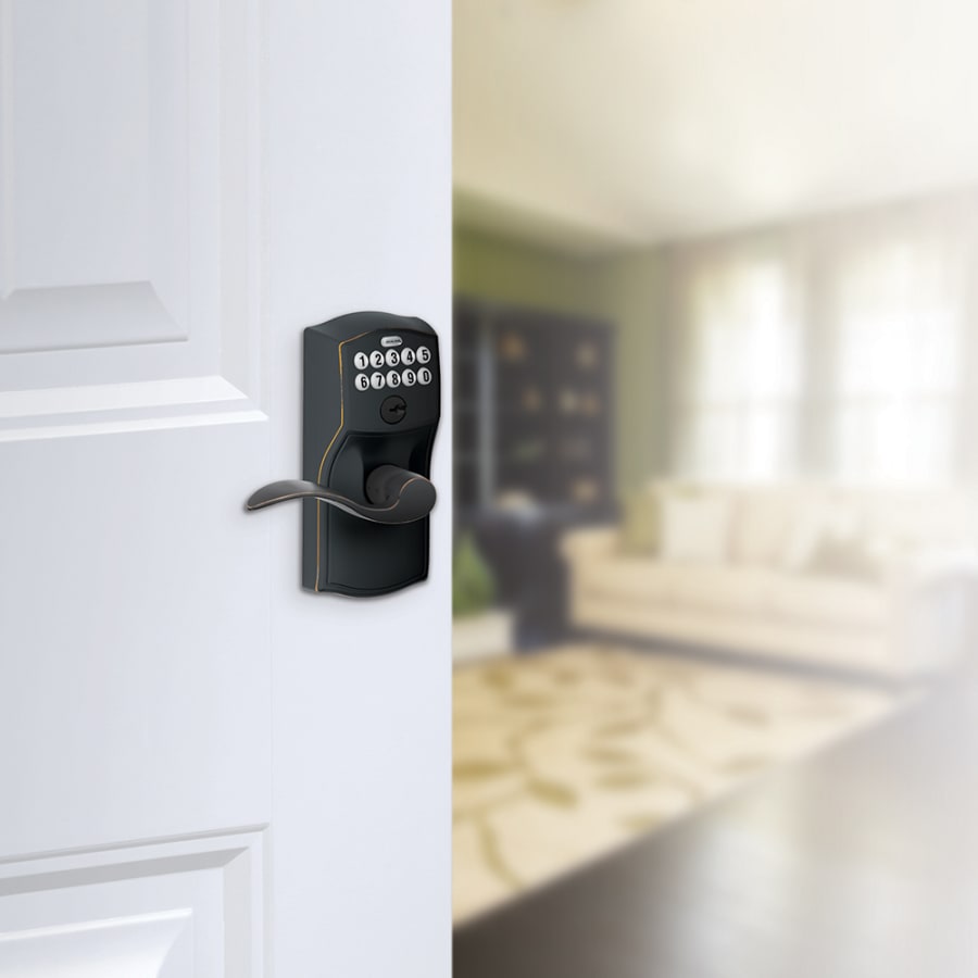 Schlage's FE595-CAM-ACC in Aged Bronze on door.