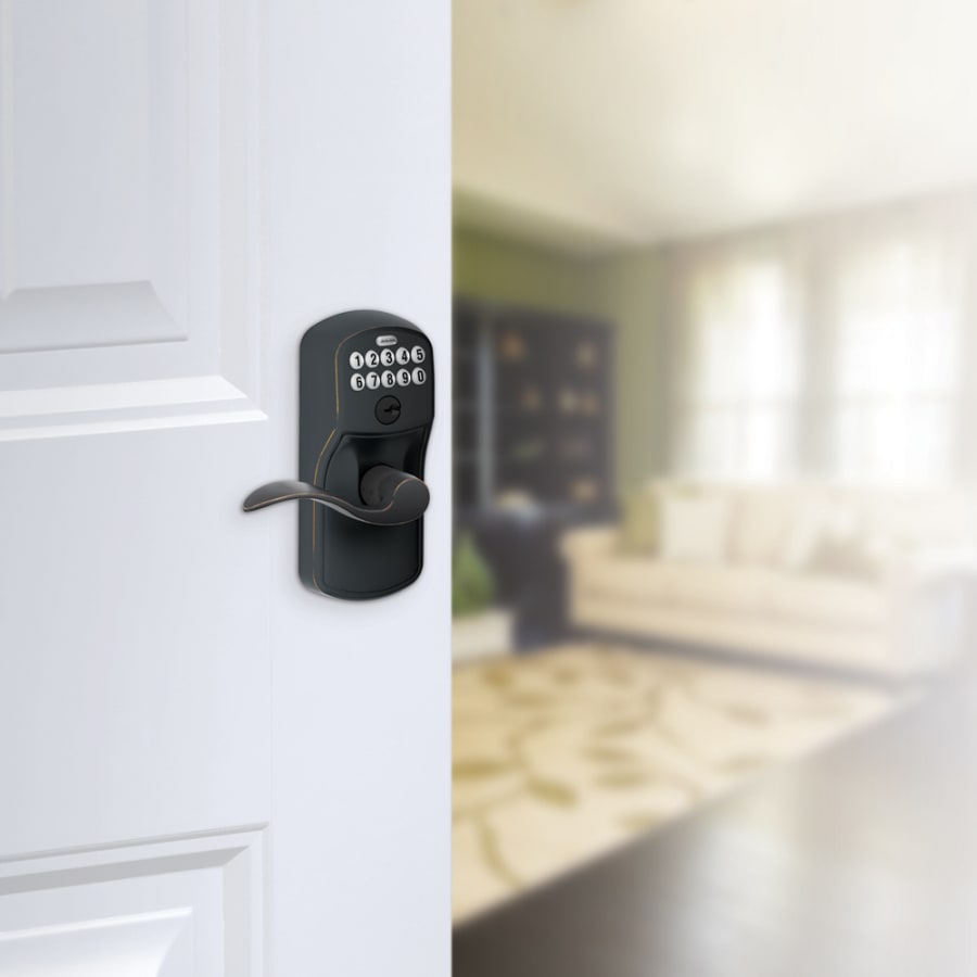 Schlage's FE595-PLY-ACC in Aged Bronze on door.