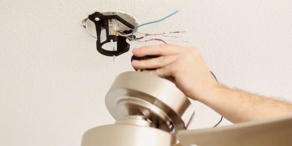 Attaching the fitting to the mounting hardware on ceiling.