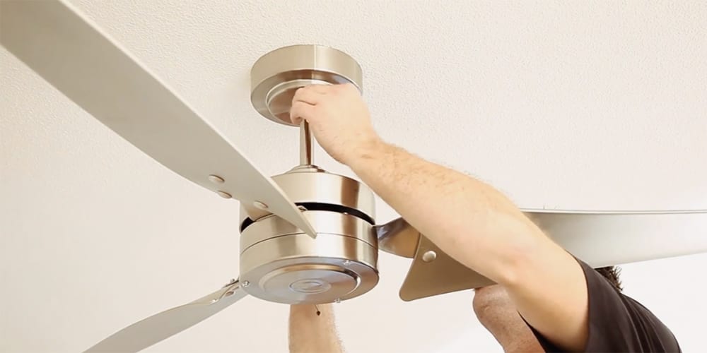 Putting new fan canopy in place and attaching it to the ceiling.