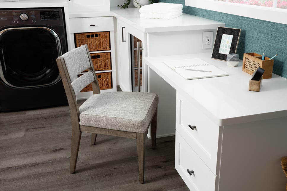 Desk workspace built-in to laundry room, wicker storage drawers