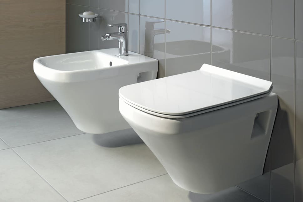 Wall mounted bidet and toilet, gray tile.