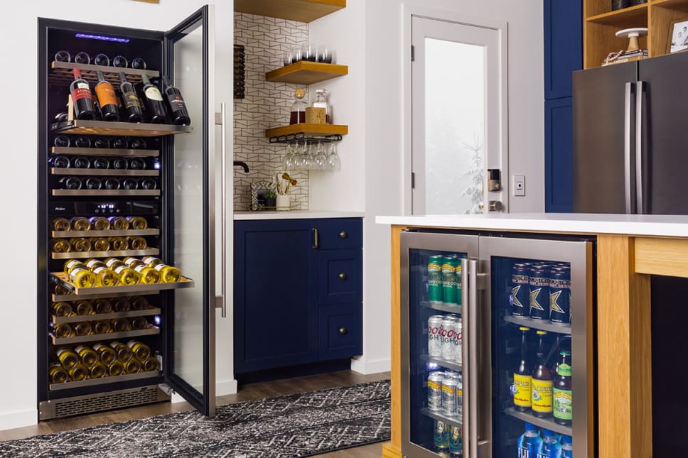 black bottles of wine, dark blue cabinets, stainless steel beer fridge